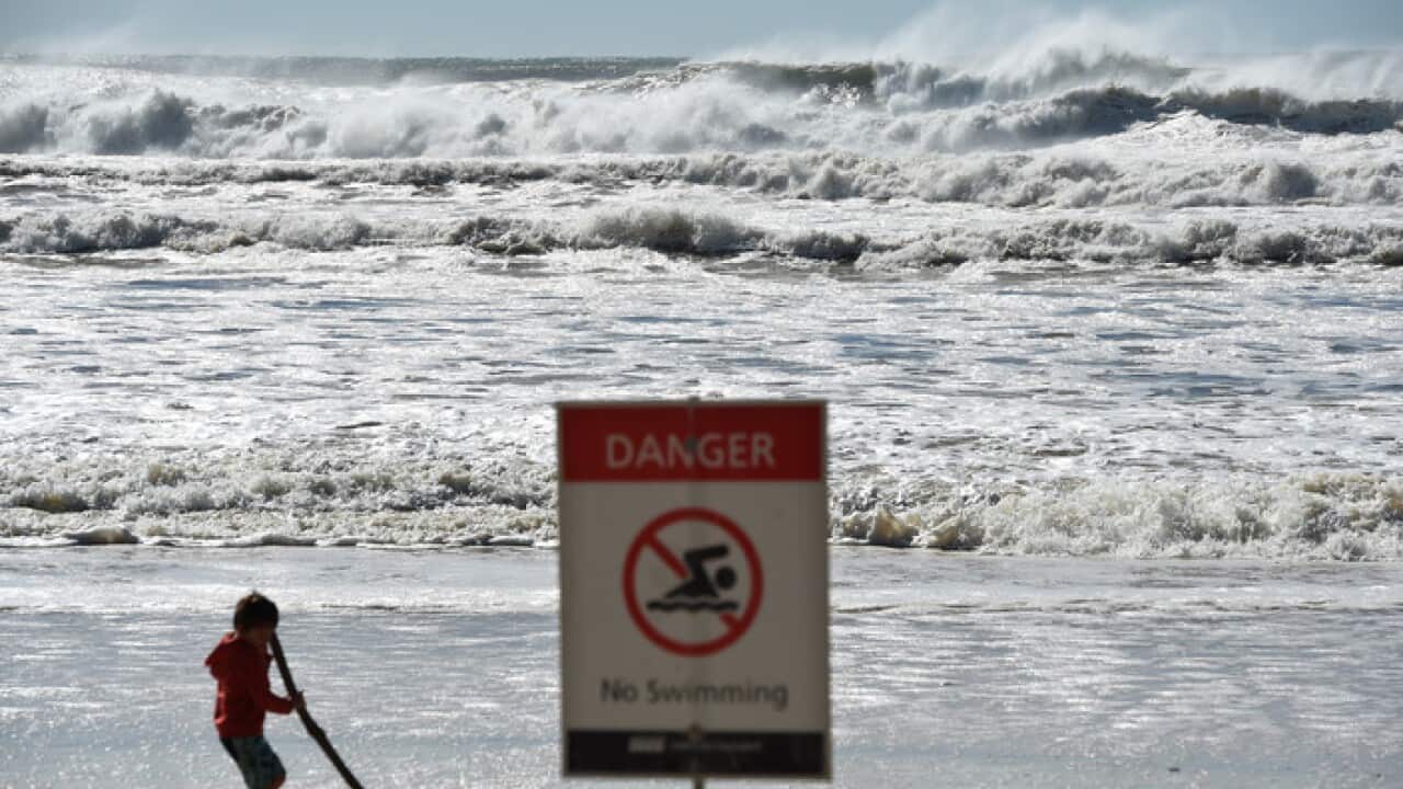 A sign informing the beach is closed at Burleigh Heads on the Gold Coast