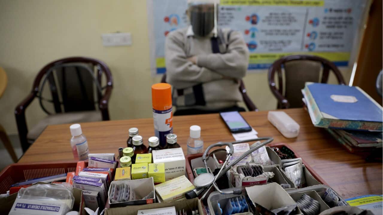 A doctor waits at an Indian vaccination room (AAP).jpg