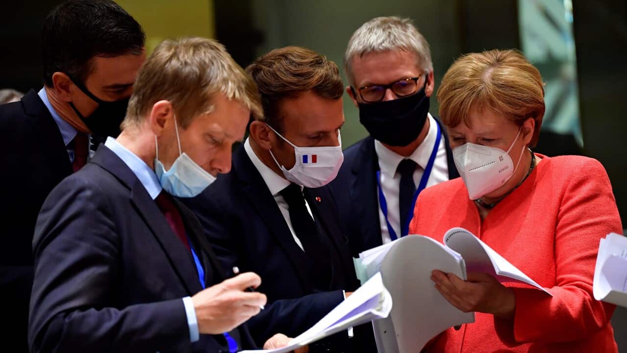 German Chancellor Angela Merkel and French President Emmanuel Macron wearing face masks on the fourth day of of the virus recovery summit in Brussels.