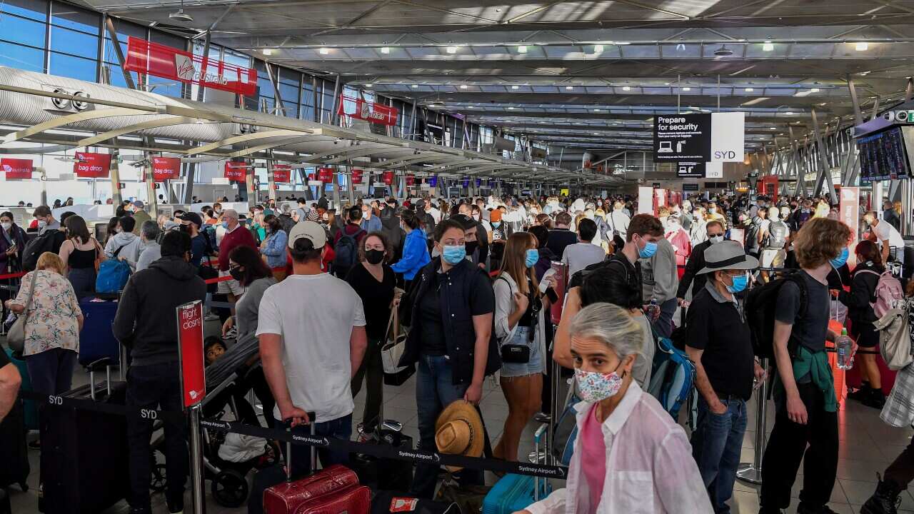Queues of people are seen at the Virgin and Jetstar departure terminal at Sydney Domestic Airport in Sydney.