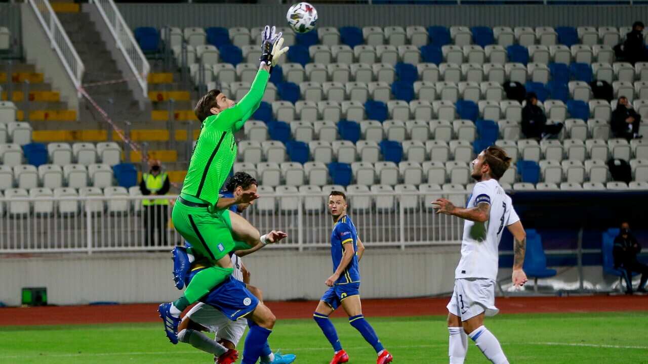 Goalie Vasilis Barkas of Greece jumps for the ball on top of Atdhe Nuhiu of Kosovo during the UEFA Nations League soccer match between Kosovo and Greece at Fadil Vokrri Stadium in Pristina, Kosovo, Sunday, Sept. 6, 2020.
