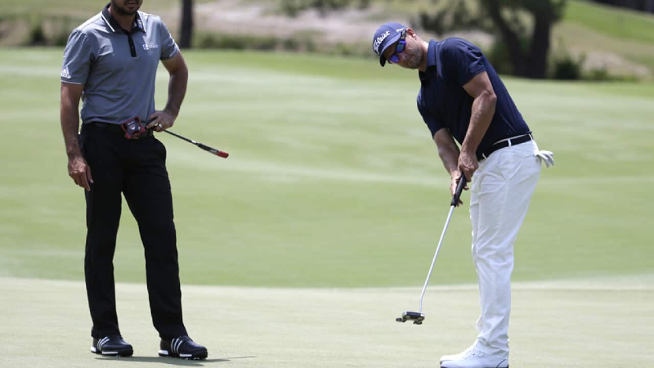 Australian golfer Adam Scott (R) and Jason Day