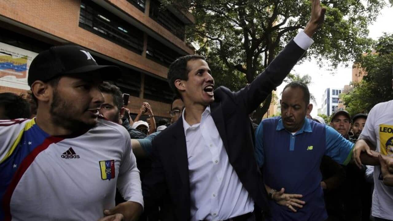 Juan Guaido waves at supporters