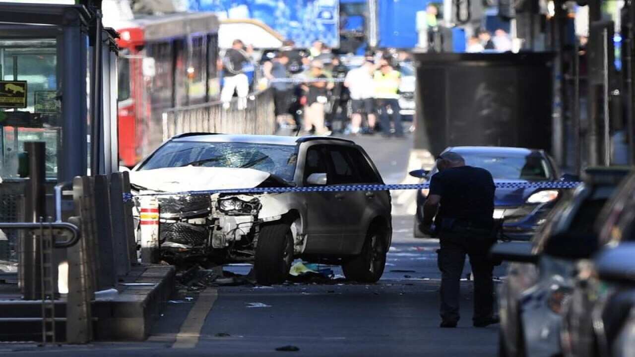 A damaged vehicle is seen at the scene of an incident