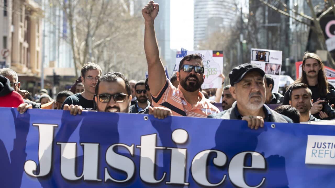 Demonstrators march during a rally calling for refugee rights.