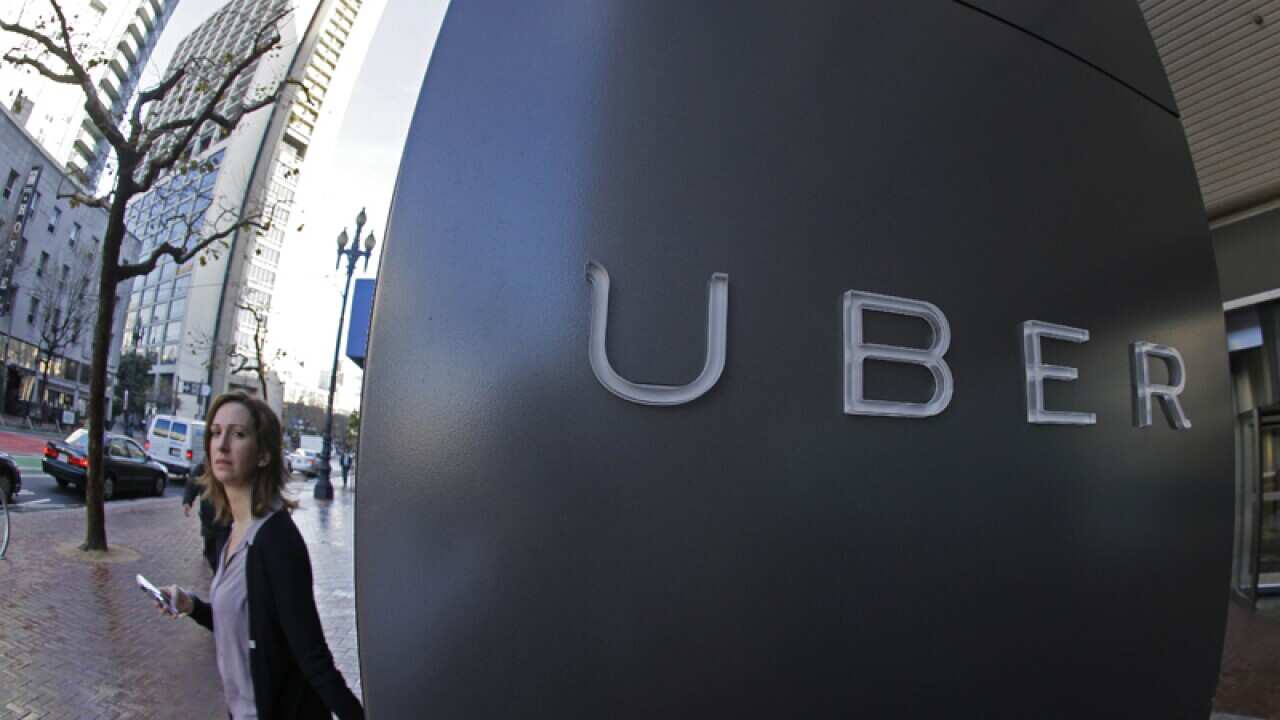 A woman leaves the headquarters of Uber in San Francisco