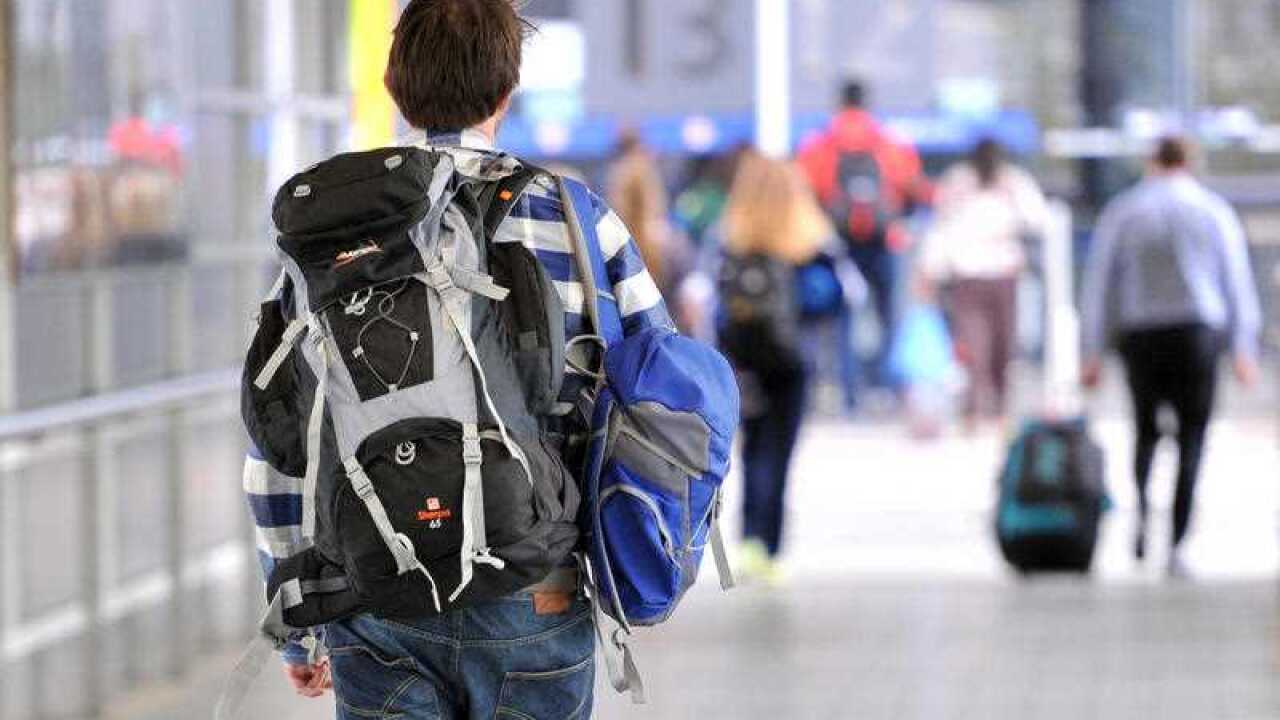 A backpacker makes his way to the international terminal at Melbourne Airport in Melbourne, Wednesday, April 23, 2014. (AAP Image/Julian Smith) NO ARCHIVING