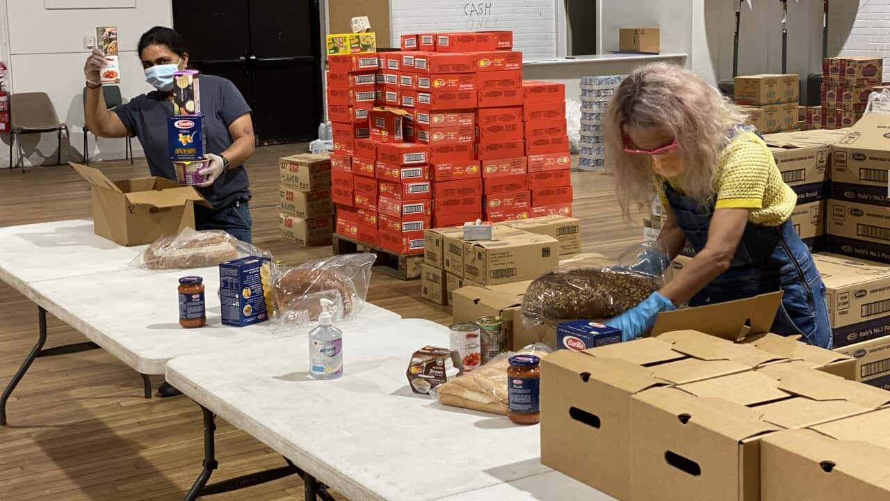 Rosanna Barbero and Gurwinder Kaur preparing food boxes at Addi Road.