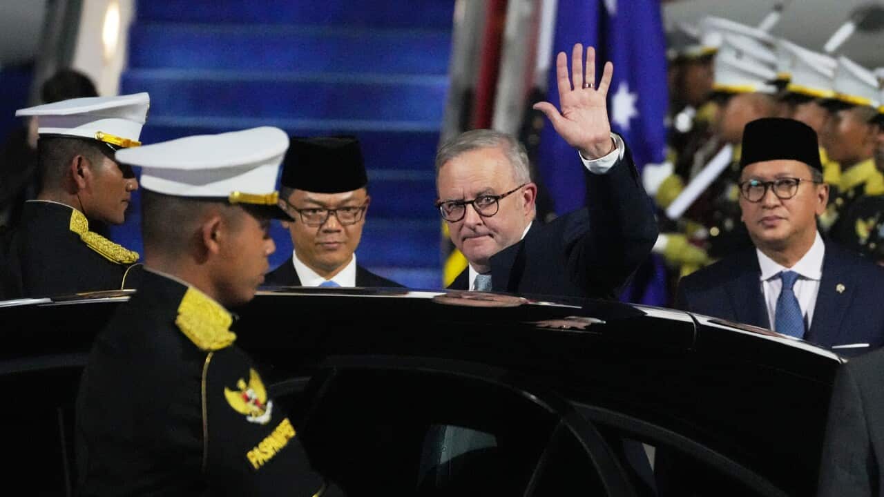 Prime Minister Anthony Albanese waving upon arrival in Indonesia
