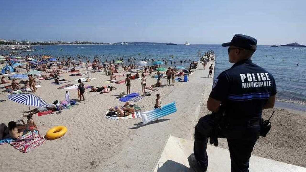 French police officer patrols on the beach of Cannes, in security measures after the Nice terror attack, in Cannes, France, 04 August 2016.