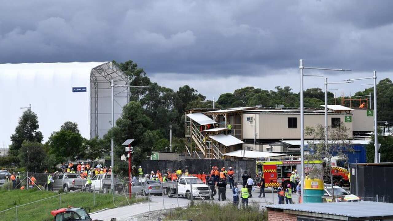 A man has died and another is critically injured after scaffolding collapsed on the pair at a Sydney worksite.