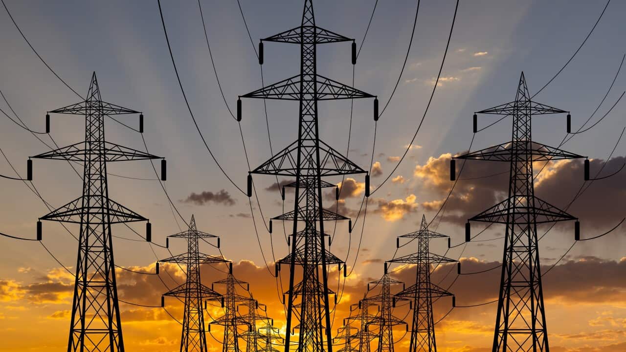 High voltage towers at sunset background. Power lines against the sky