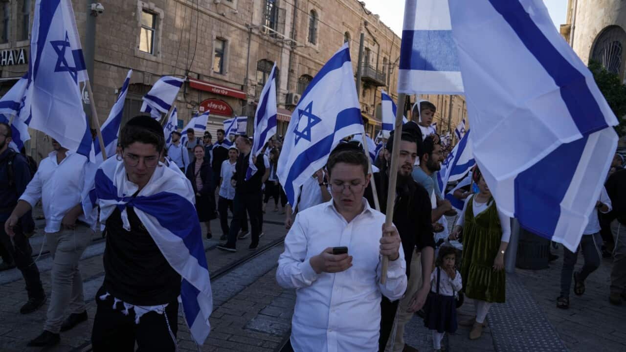 Activists with Israeli flags gather for a march