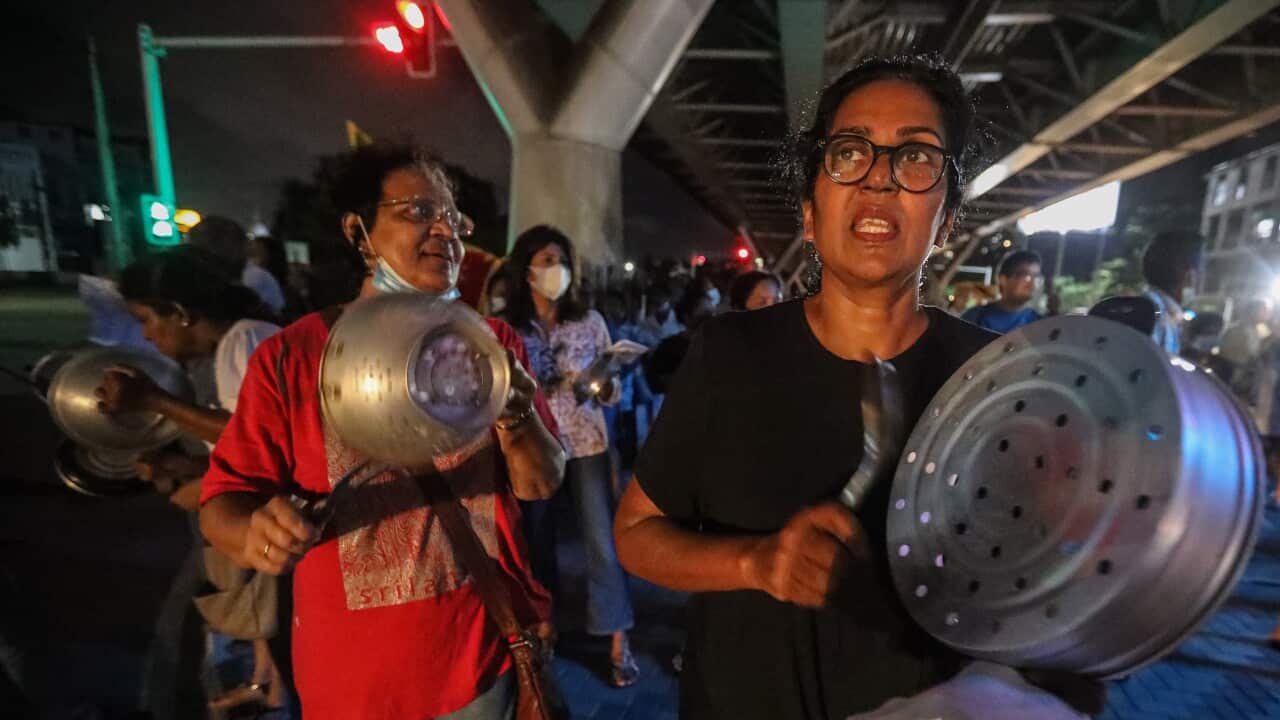 Women bang pots and pans as part of a protest