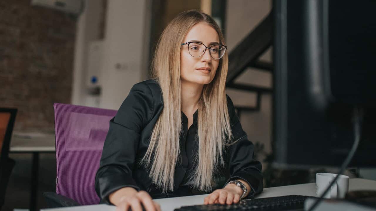 Businesswoman using computer and drink coffe at desk