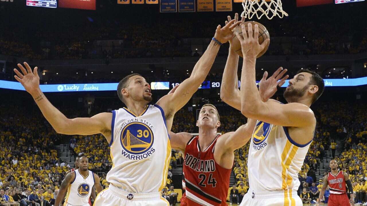 Golden State Warriors' guard Stephen Curry (L) and center Andrew Bogut
