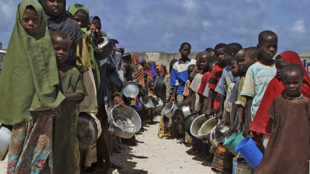 Children line up to receive cooked food in Mogadishu, Somalia.