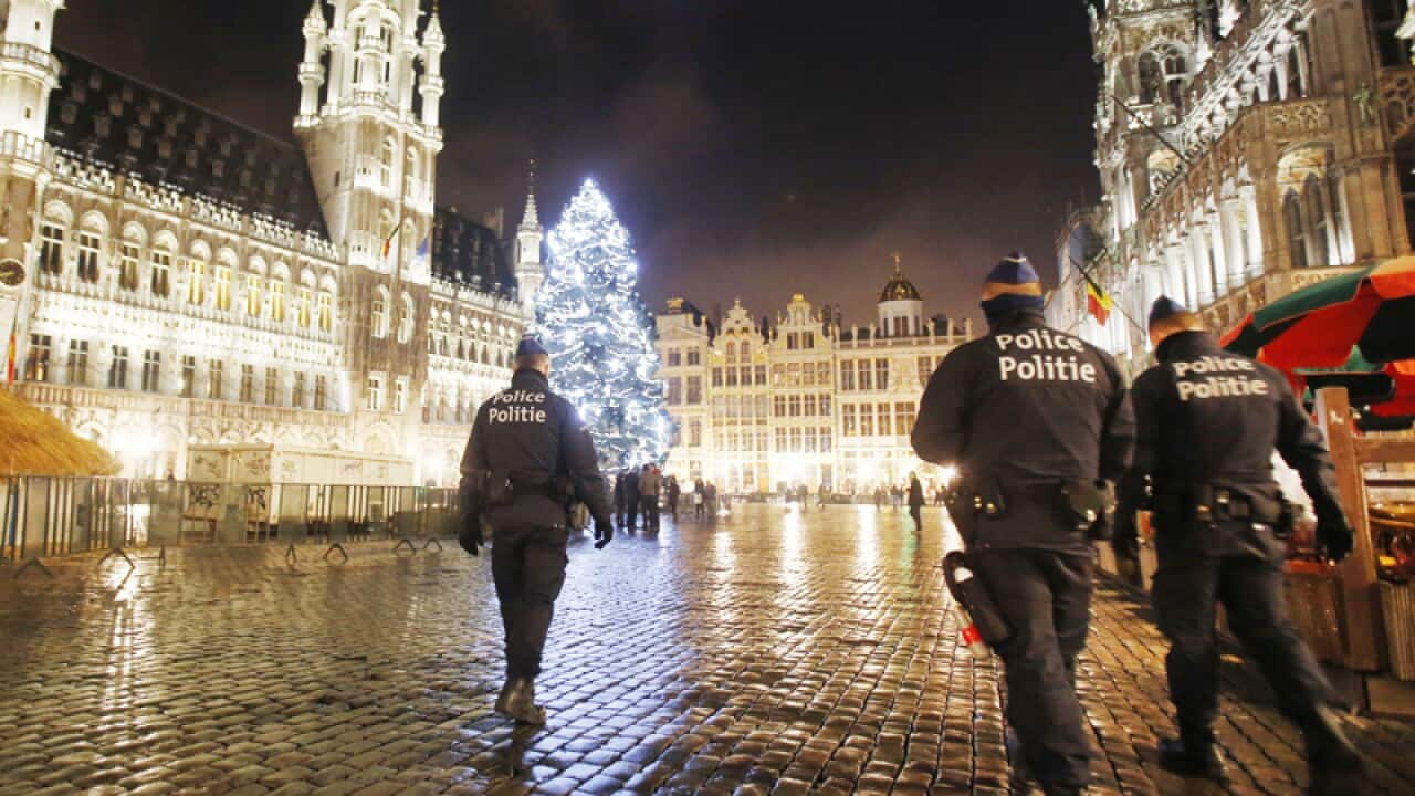 Belgian police officers patrol the Grand Place in downtown Brussels
