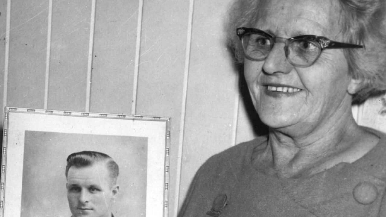 Thelma Healy in front of a picture of her son Sergeant Vincent Healy
