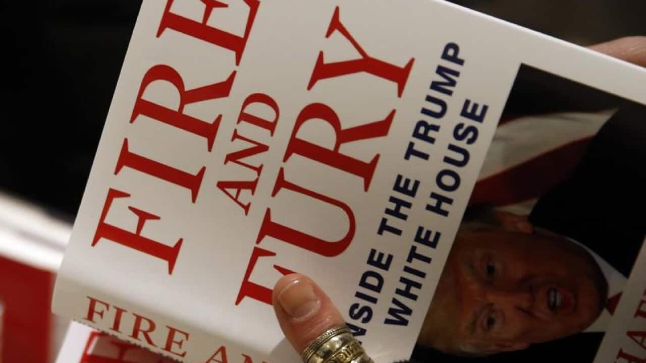 A customer looks at a copy of Michael Wolff's "Fire and Fury
