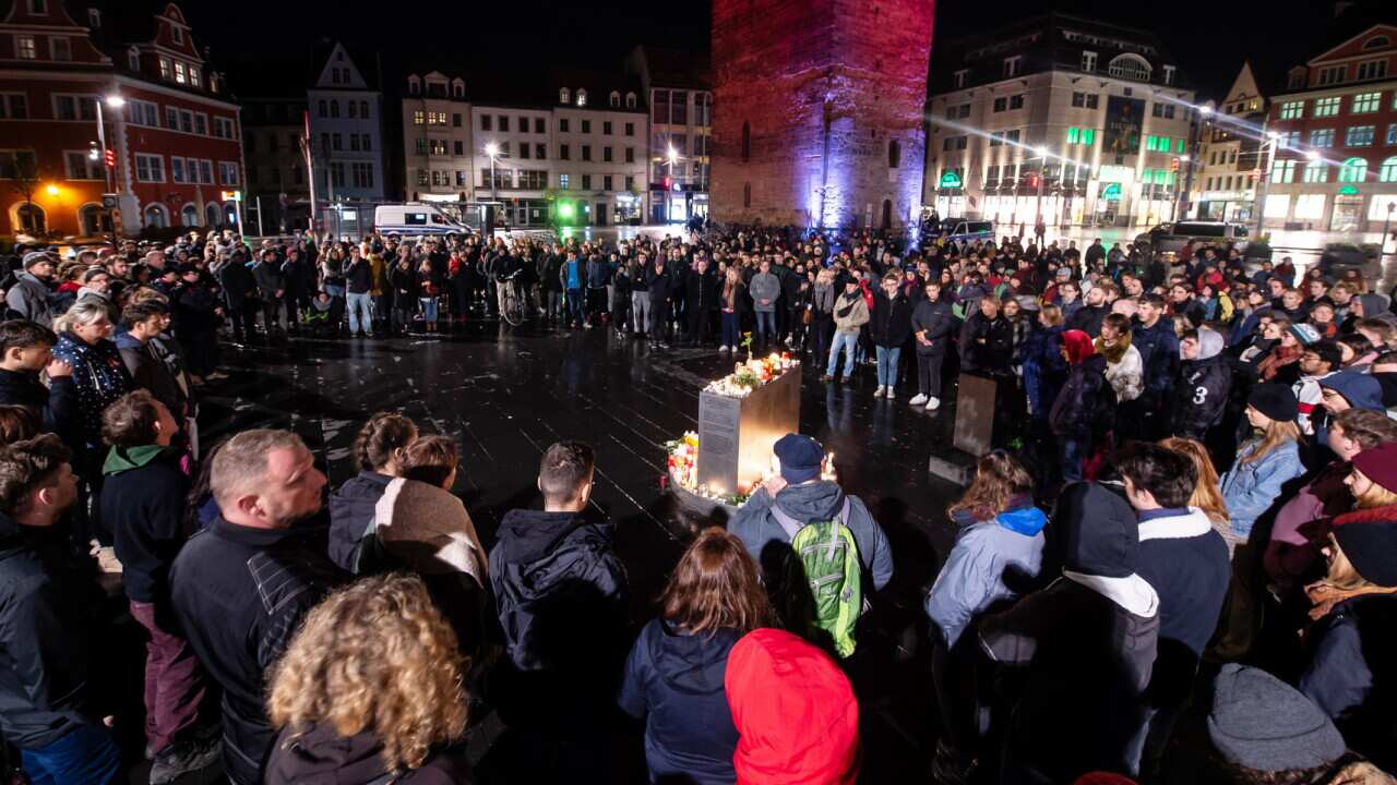 Mourners gather in Halle's market square following the attack on a Synagogue