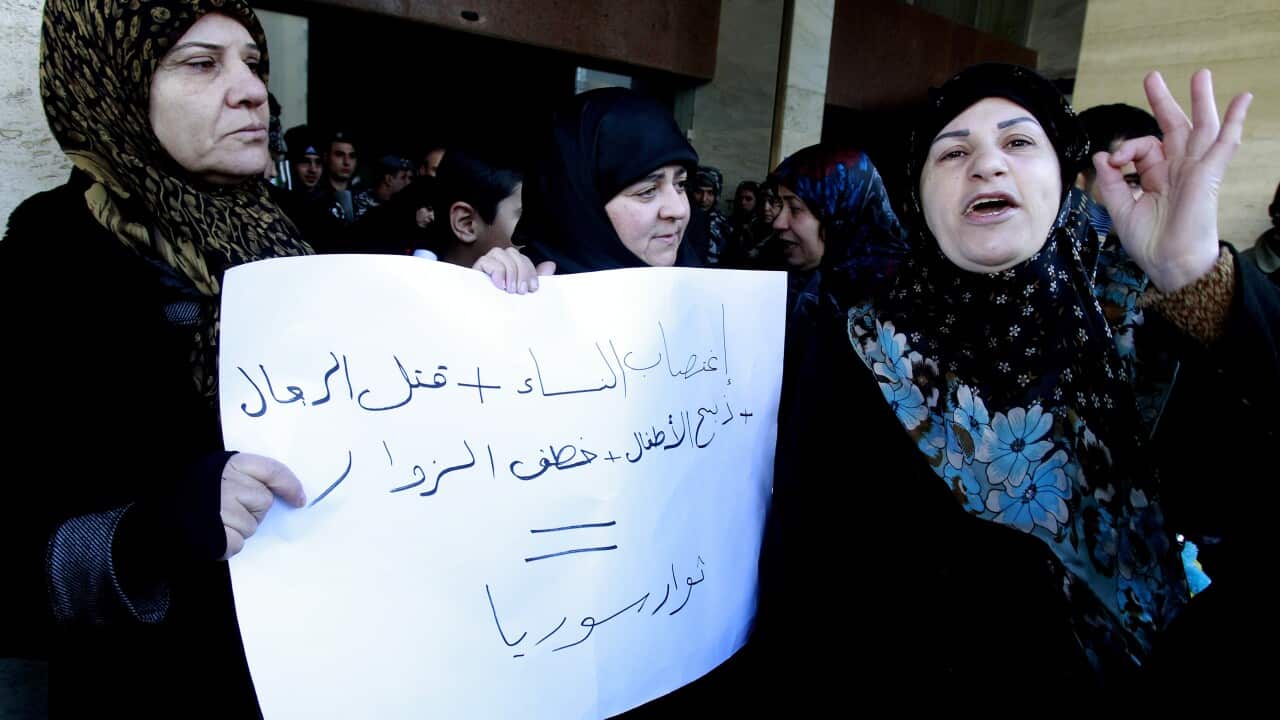 Relatives of Lebanese Shiite pilgrims kidnapped last May in Syria hold a placard and shout slogans during a protest in front of the Qatari embassy in Beiru