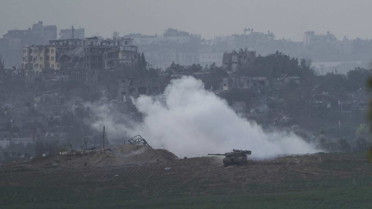 A tank surrounded by smoke and buildings