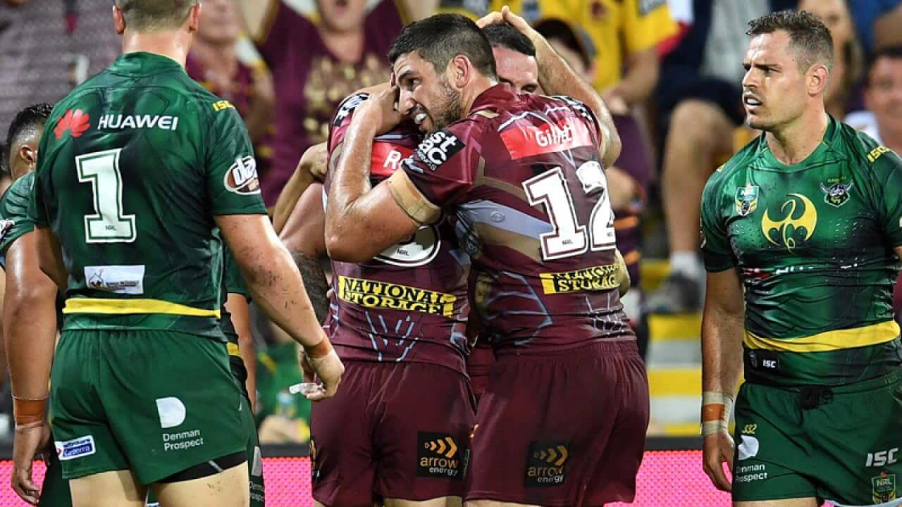 Brisbane Broncos players celebrate a try