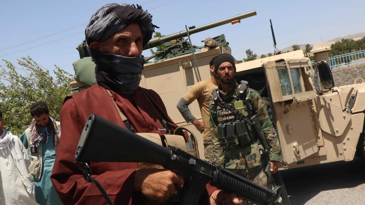 Afghan security officials and private militia patrol after they took back control of parts of Herat city after a battle with Taliban militants on 5 August.