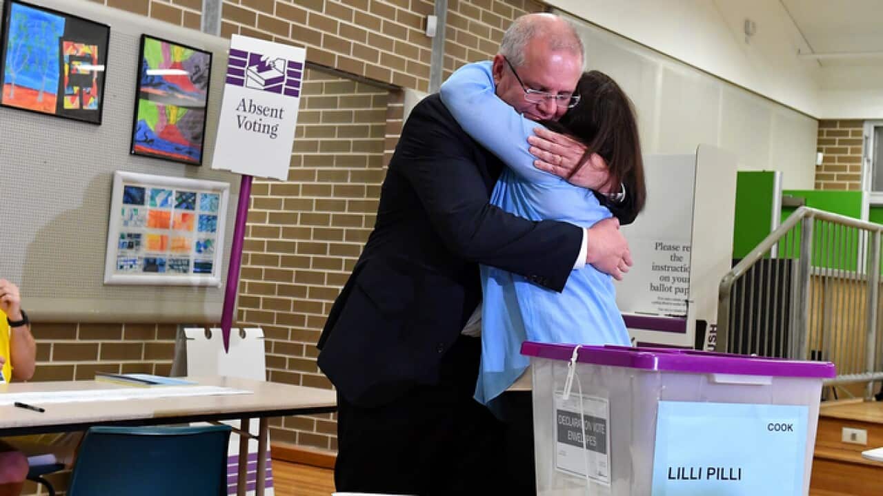 Australian Prime Minister Scott Morrison reacts after casting his vote alongside wife Jenny, on Election day, in Sydney, Saturday, 18 May, 2019.