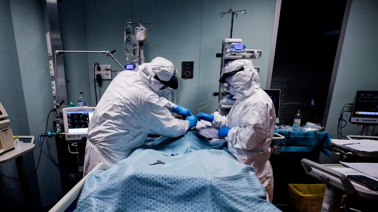 Doctors and nurses wearing protective equipment