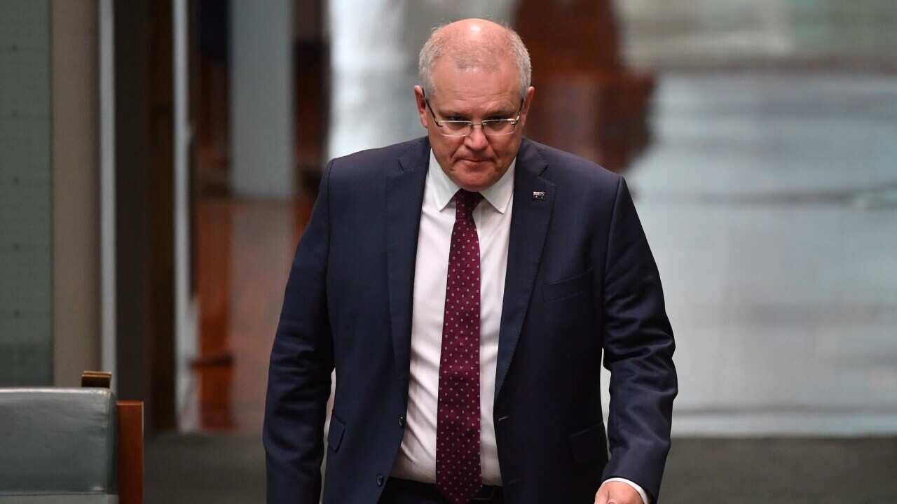 Prime Minister Scott Morrison arrives to listen to Treasurer Josh Frydenberg making a ministerial statement to the House of Representatives at Parliament House in Canberra, Tuesday, May 12, 2020. (AAP Image/Mick Tsikas) NO ARCHIVING