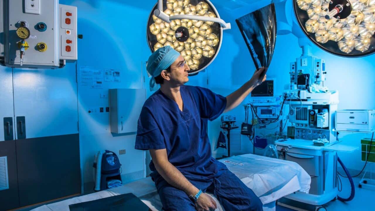 Dr Munjed Al Muderis examines an X-ray.