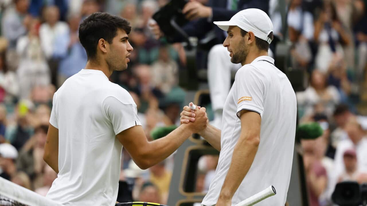 Aleksandar Vukic (R) of Australia congratulates Carlos Alcaraz of Spain after their second round match against at the Wimbledon Championships