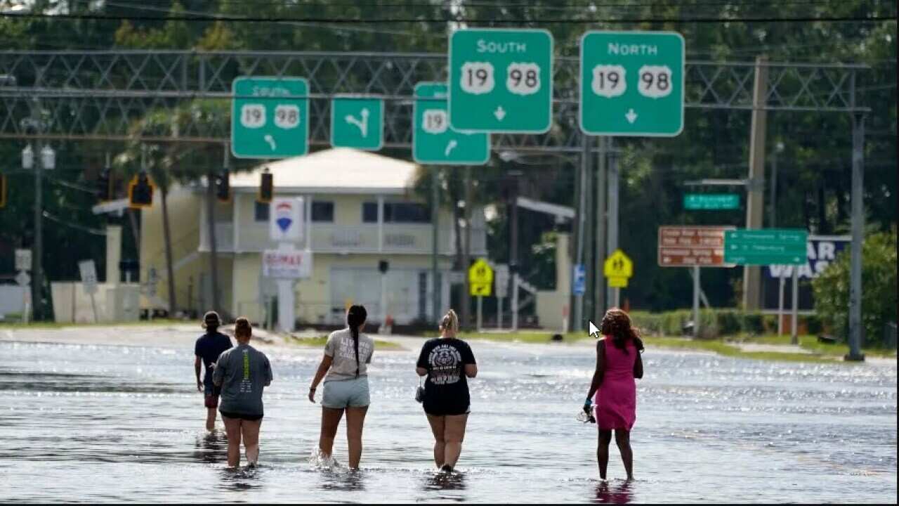 People walk through floodwaters in Crystal River, Florida. (AAP) New.jpg