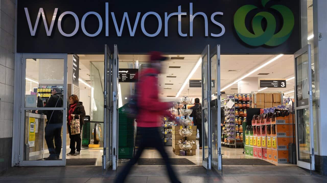 Shoppers walk past a Woolworths store in Sydney.