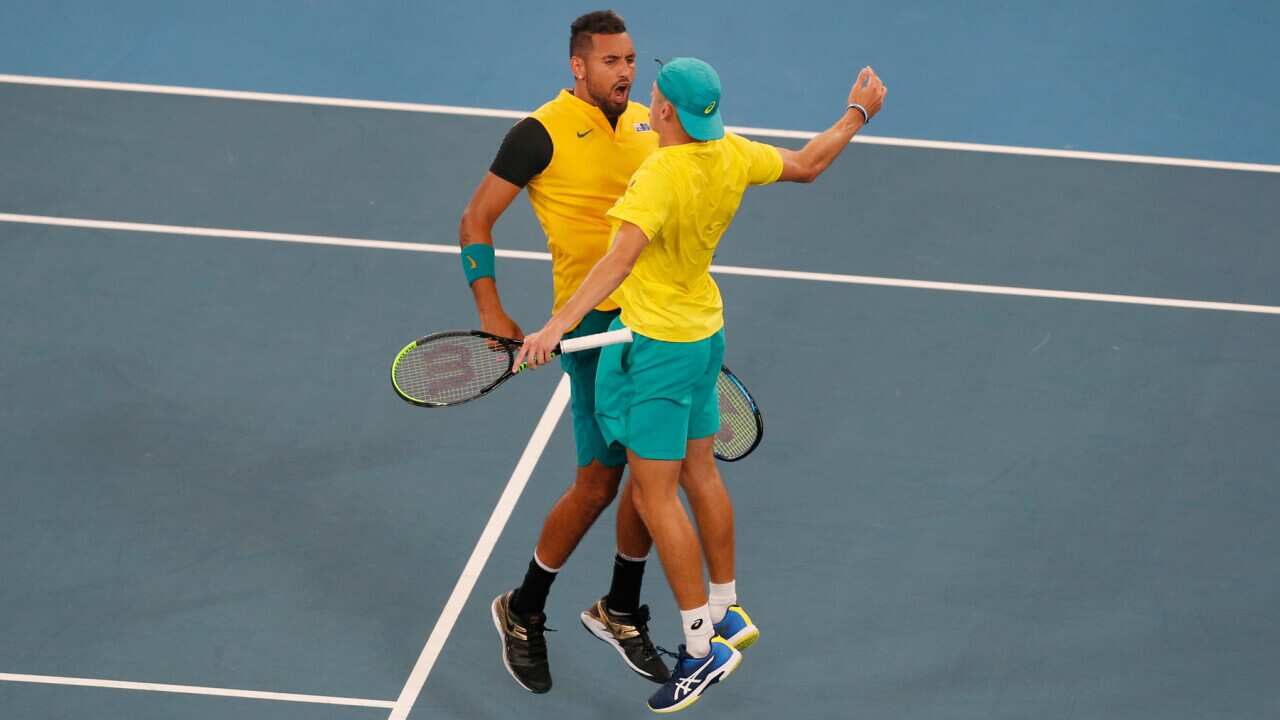 Australia's Alex De Minaur, left, and Nick Kyrgios celebrate after winning a match point against Britain's Jamie Murray and Joe Salisbury during their ATP Cup tennis doubles match in Sydney, Thursday, Jan. 9, 2020. (AP Photo/Steve Christo)