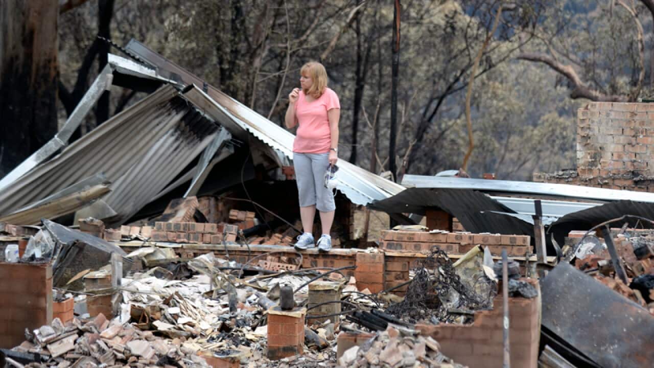 Karen Bousfield is seen at her burnt down property in Winmalee