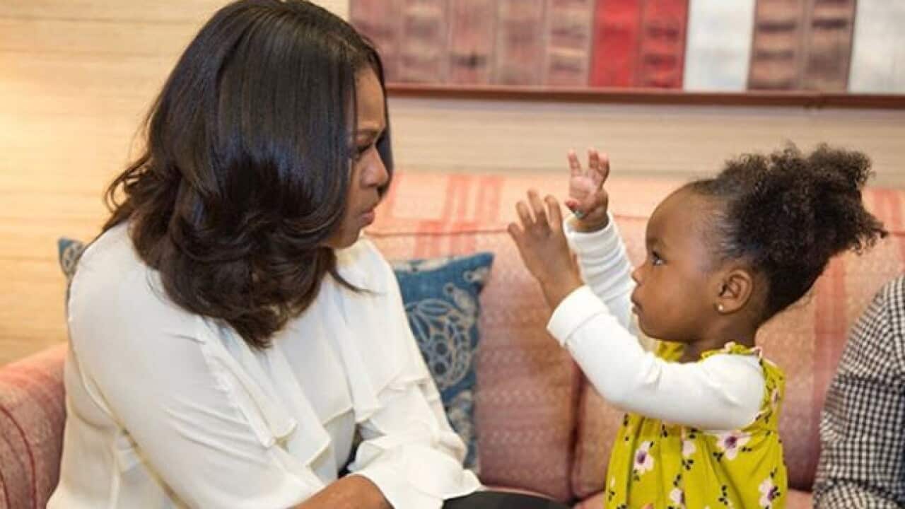 Michelle Obama with young Parker Curry.