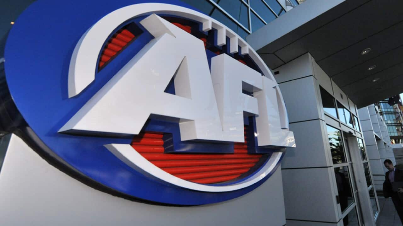 A man in a suit arrives at AFL House in Melbourne