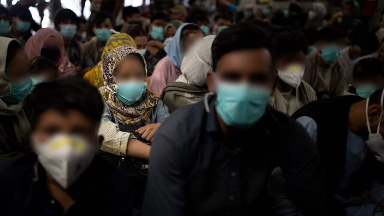 Australian citizens and visa holders travel onboard an evacuation flight on Monday, August 23, 2021