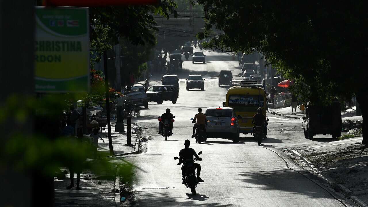 People drive on a main road in Port-au-Prince, Haiti, three days after President Jovenel Moise was assassinated.