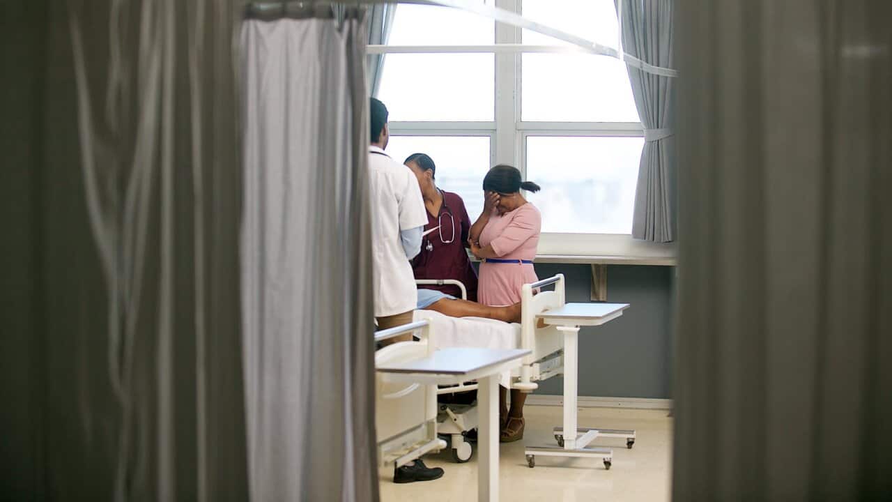 A doctor talks to a patient's family
