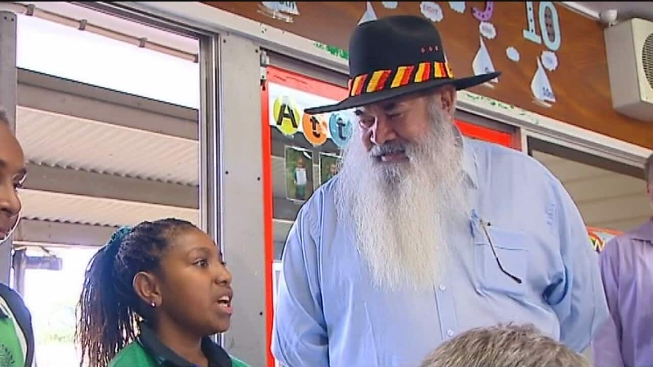 Pat Dodson listens to a school child on the campaign trail.