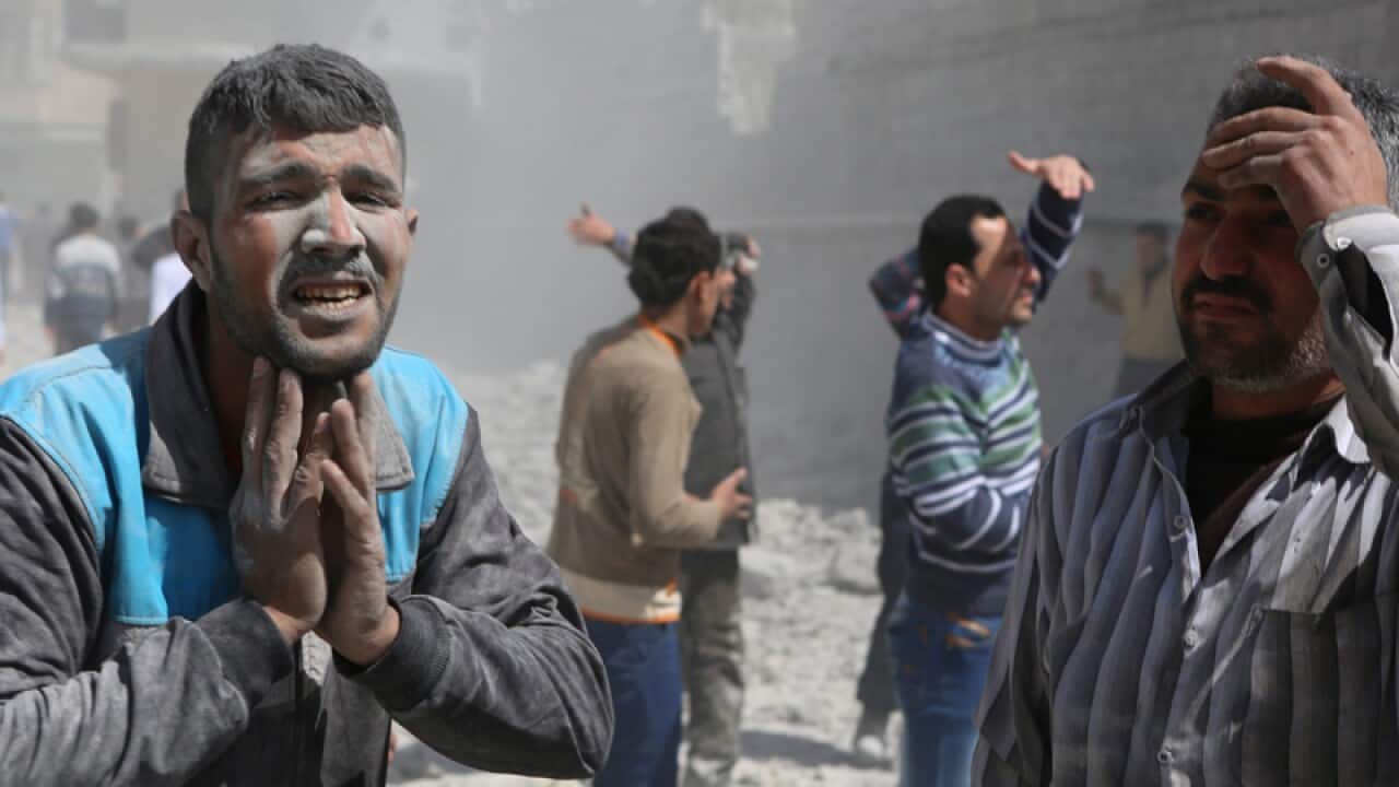 People react after a missile attack, in Aleppo, Syria