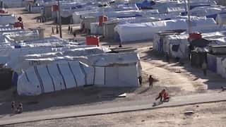 Tents that make up the refugee camp, separated by dirt paths where children play.