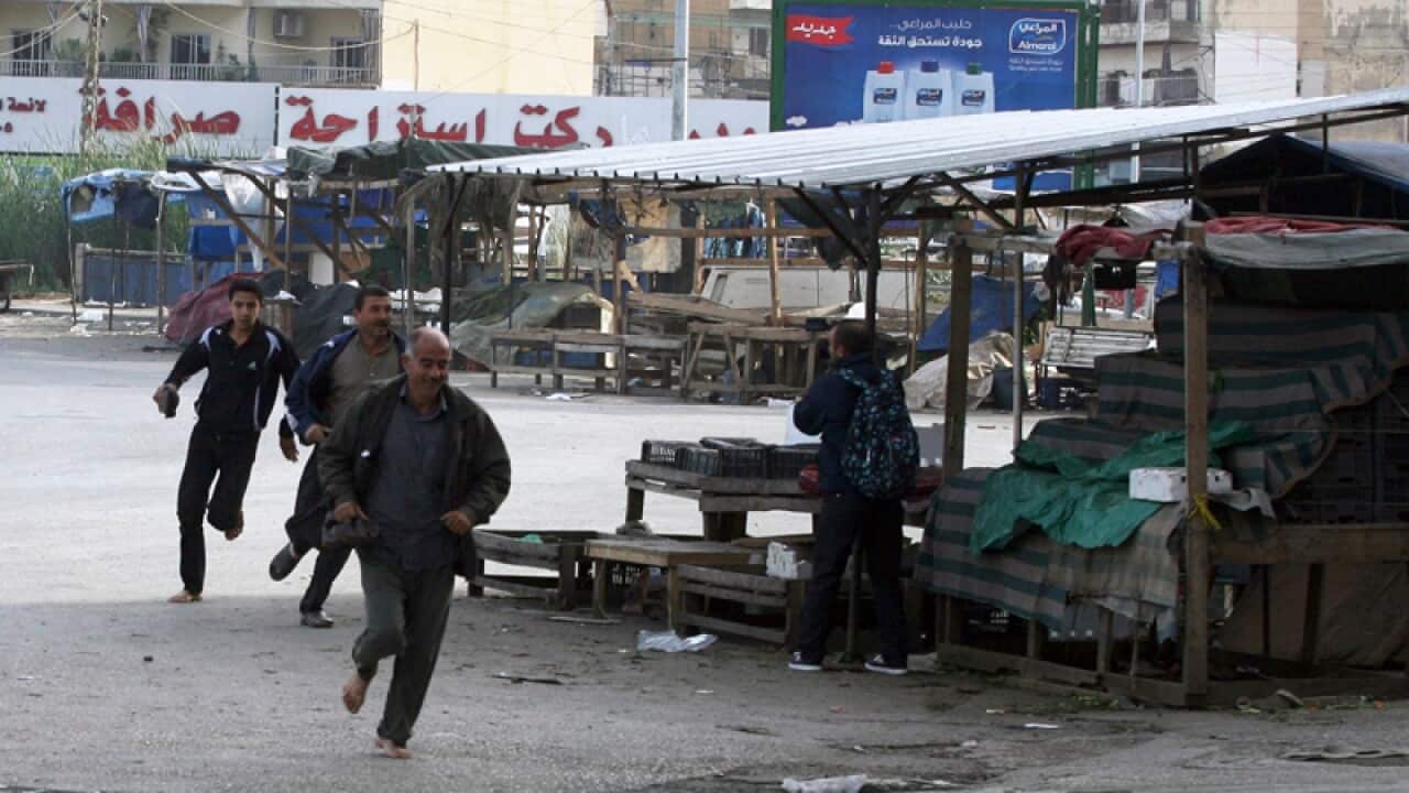 People run for cover from sniper fire in Tripoli
