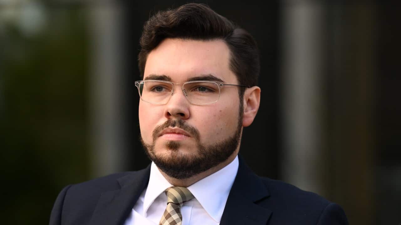 A man wearing glasses in a suit