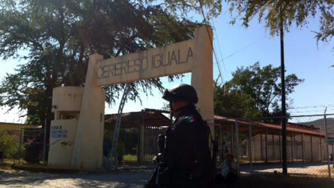 Policemen watches over the entrance of a prison at Iguala, Mexico