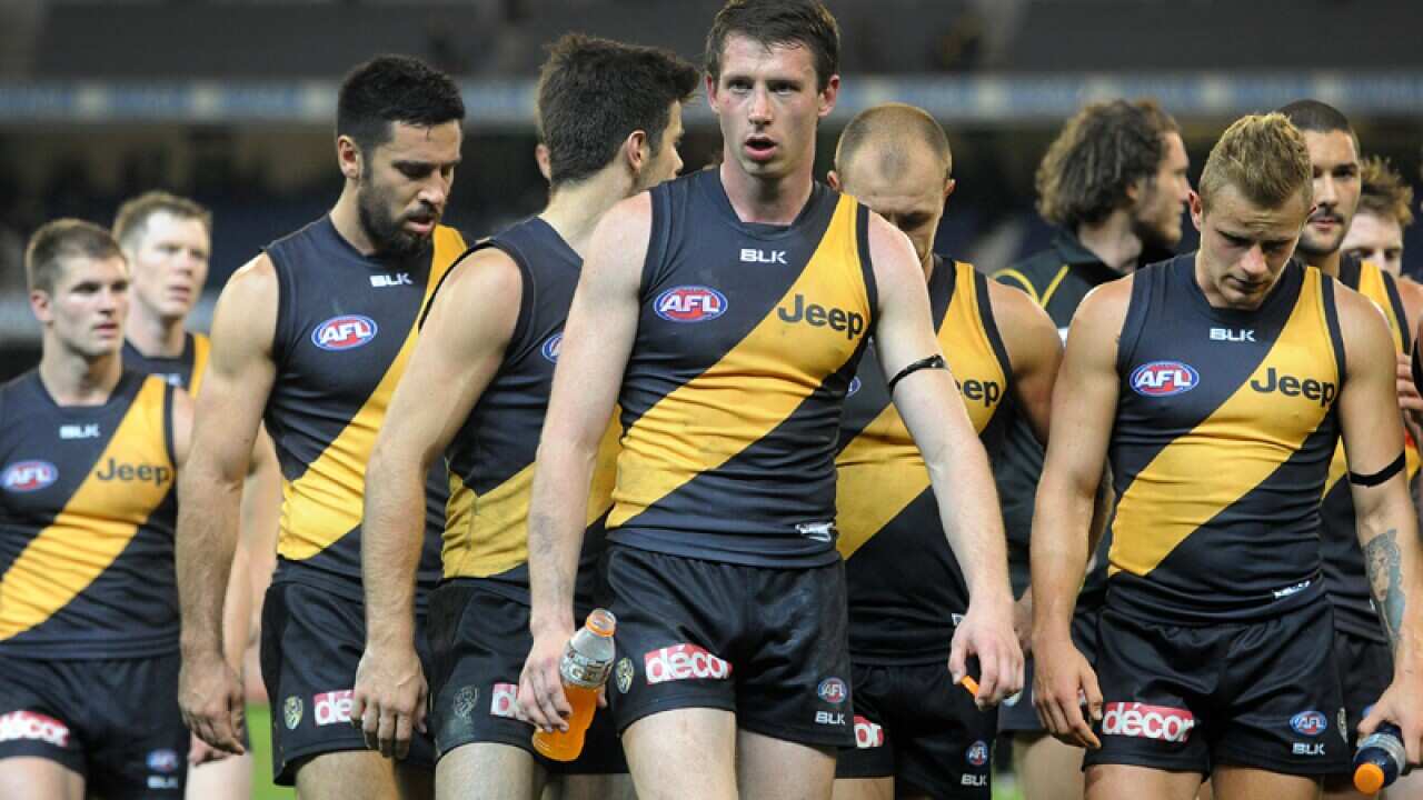Richmond players walk off the ground after their loss